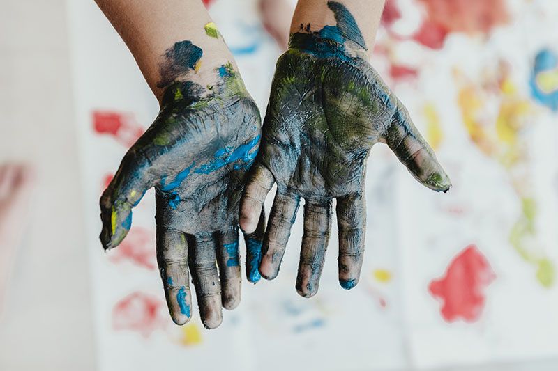Child's hads covered in paint